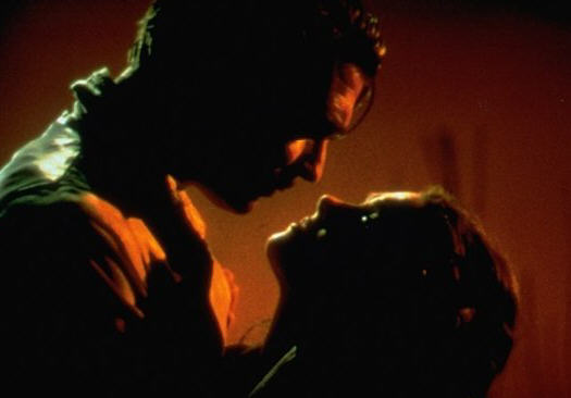 Scarlett O'Hara and Rhett Butler, with Atlanta burning in the background.